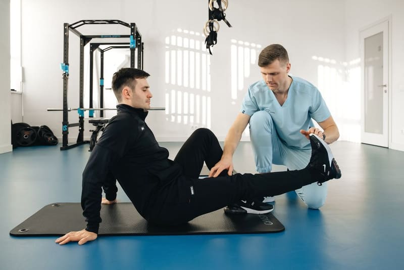 Physiotherapist guiding a patient through a rehabilitation exercise